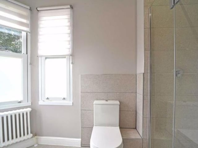 The shower room - joining on from the dressing room - has a vanity wash basin, a shower cubicle with a rain shower and a fitted wall mirror with integral lighting.