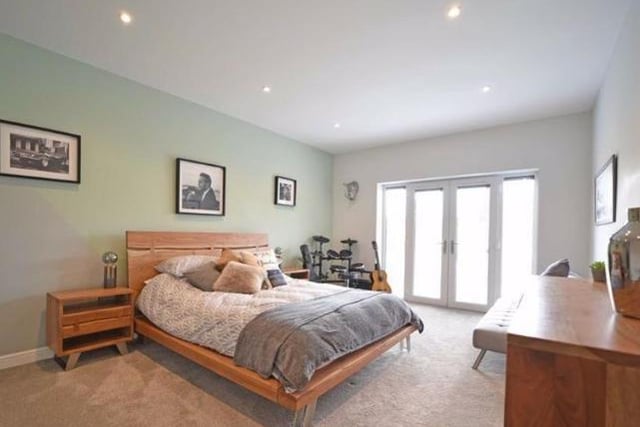 A very spacious double room with a high ceiling with LED downlighters and french doors opening to a glazed juliet balcony overlooking the rear garden.