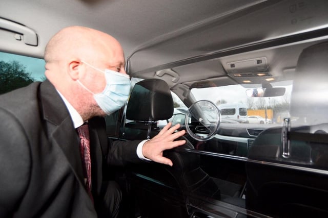 Peter Reeves MBE demonstrating the safety measures in place inside the taxis.