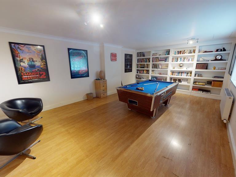 This games room offers more space to play pool in comfort than most pubs