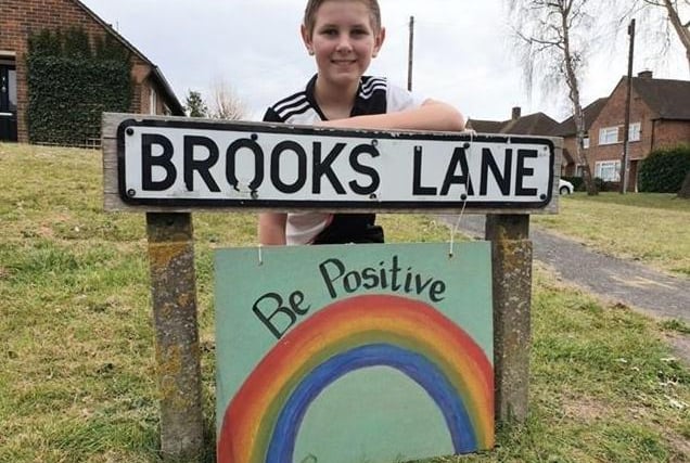Joshua Bickell, 10, makes colourful signs to hang around Bosham