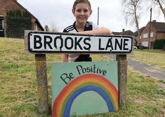 Joshua Bickell, 10, makes colourful signs to hang around Bosham