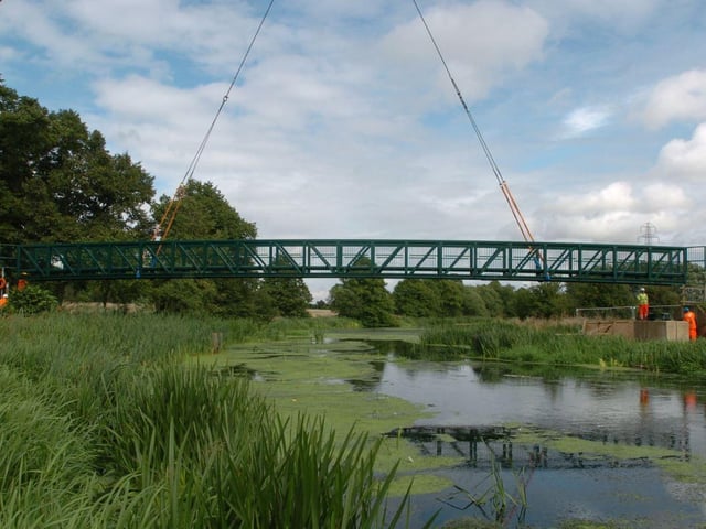 A new bridge goes into place in Midsummer Meadow, Bedford Road on Wednesday, 12th August 2009