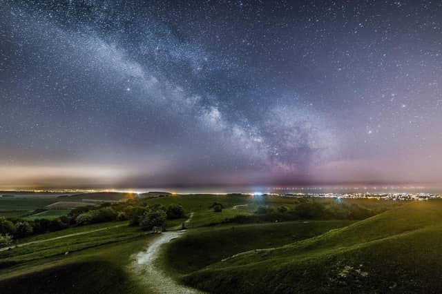 The milkyway above the lights of Worthing and Brighton from Cissbury Ring by Neil Jones SUS-220702-091031001