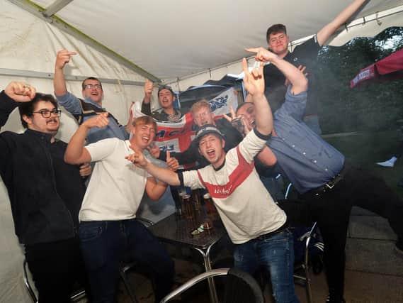 Fans celebrate the England victory at the Royalist pub on Western Avenue in Market Harborough.