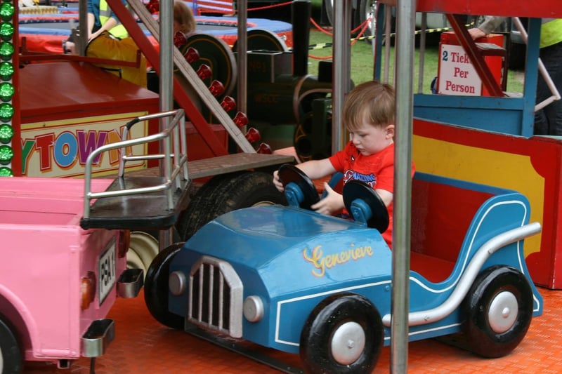 A little driver enjoys the merry-go-round. Picture by Graham Hazard