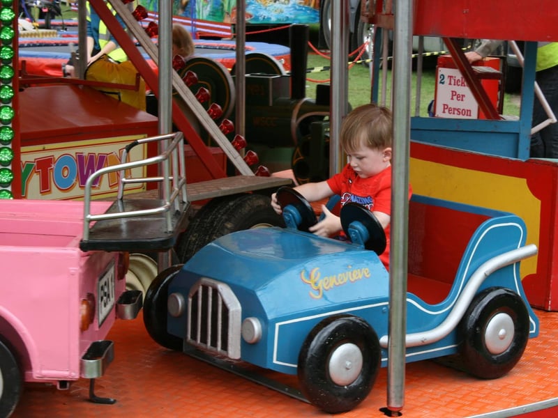 A little driver enjoys the merry-go-round. Picture by Graham Hazard