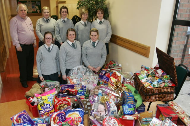 Thornhill college students Natasha McCallion, Jennifer Willis, Aisling Strawbridge, Sarah Walsh, Rachel Paige, Amie Campbell and Theresa McLaughlin with school teacher Eamon McLaughlin as some of the large amount of hampers they collected for the needy in Derry.  (2212JB10)