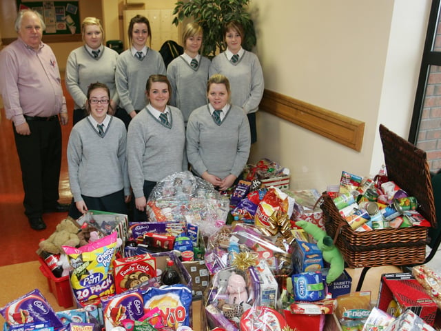 Thornhill college students Natasha McCallion, Jennifer Willis, Aisling Strawbridge, Sarah Walsh, Rachel Paige, Amie Campbell and Theresa McLaughlin with school teacher Eamon McLaughlin as some of the large amount of hampers they collected for the needy in Derry. (2212JB10)