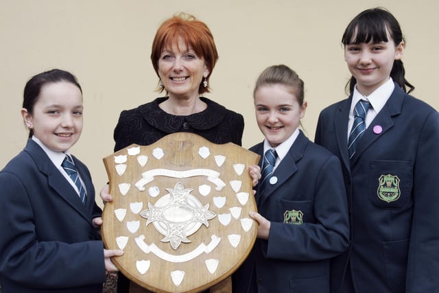 Thornhill College students Laura Doherty, Jemma Cooke and Shannon Hegarty presenting the Bishop's Shield for the Best Overall School at Feis Dhoire Cholmcille to Mrs. Sarah Kelly, principal. (2804C11)