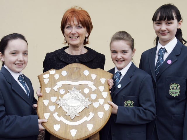 Thornhill College students Laura Doherty, Jemma Cooke and Shannon Hegarty presenting the Bishop's Shield for the Best Overall School at Feis Dhoire Cholmcille to Mrs. Sarah Kelly, principal. (2804C11)