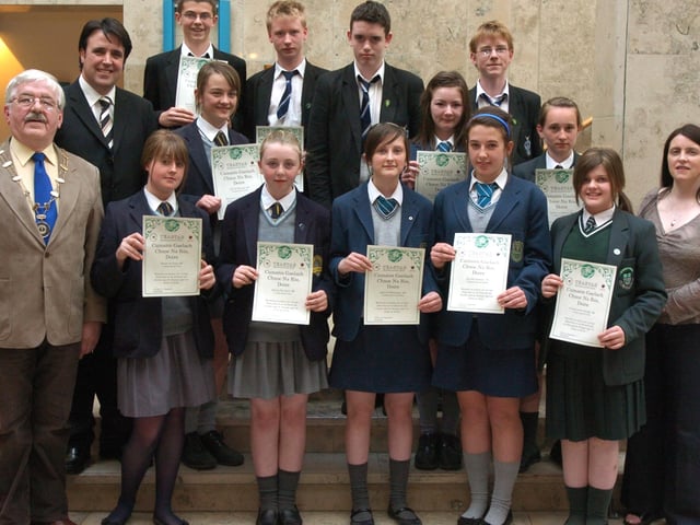 Cumann Gaelach Chnoc na Ros, in conjunction with Derry City Council, present bursaries to pupils and adults who will be participating in Irish courses in Donegal this summer. Included are Risteard Mac Gabhann, Uachtaran Oireachtas na Gaelige, Councillor Gearard Diver, and Clar Ni Chnaimhsi, Gaelic officer. Schools represented at the presentations were Lumen Christi, St Cecilia's College, Thornhill College, St Columbs College, and St Patricks College, Dungiven. ( 0606PG08)