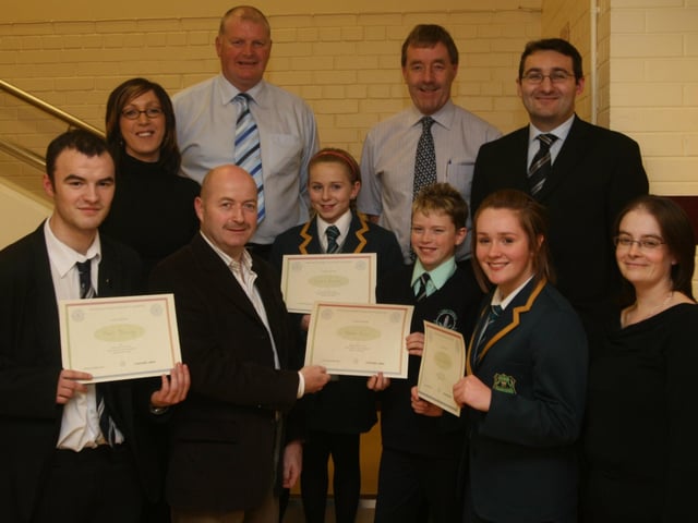 Alwyn Warnock, chairperson, Foyle and District Road Safety Committee, presenting certificates to section winners at the committee's annual Schools Public Speaking competitions held in the MDEC building at Altnagelvin Hospital. They are (from left), Paul Doherty, St.Columb's College, Sinead Sharkey, Thornhill College, Robert Brown, Long Tower PS, and Sarah Wallace, Thornhill College. Included back row are the competition adjudicators Brendan Stevenson, Adrian McAuley, Sammy Nicholl and Gerry Beattie and Aileen Tester, committee secretary. (2911T10).
