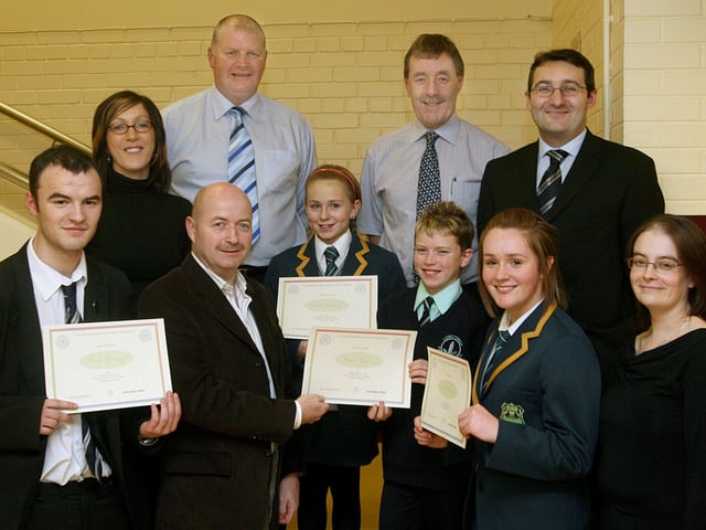 Alwyn Warnock, chairperson, Foyle and District Road Safety Committee, presenting certificates to section winners at the committee's annual Schools Public Speaking competitions held in the MDEC building at Altnagelvin Hospital. They are (from left), Paul Doherty, St.Columb's College, Sinead Sharkey, Thornhill College, Robert Brown, Long Tower PS, and Sarah Wallace, Thornhill College. Included back row are the competition adjudicators Brendan Stevenson, Adrian McAuley, Sammy Nicholl and Gerry Beattie and Aileen Tester, committee secretary. LS49-518MT.
