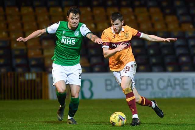 Melker Hallberg (L) and Motherwell's Liam Polworth battle for the ball