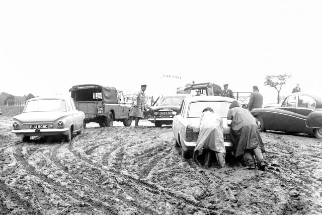 AA and RAC patrolmen assisting motorists bogged down in one of the car parks at the Royal Highland Show in 1966.