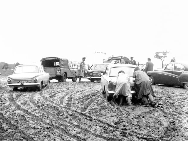 AA and RAC patrolmen assisting motorists bogged down in one of the car parks at the Royal Highland Show in 1966.