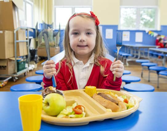 Stenhouse Primary School pupil Faith Johnston, five, receives her school lunch