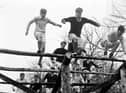 7th February 1956:  Pupils at Gordonstoun School doing physical training on an obstacle course. Gordonstoun School, near Elgin, was founded in 1934 by German educationalist Kurt Hahn who believed in a holistic approach to teaching. Creative and personal development, considered of equal merit to traditional education, is encouraged among the pupils.  (Photo by Chris Ware/Keystone Features/Getty Images)