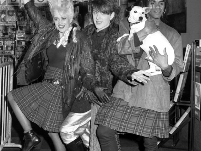 Pop stars Alana Currie and Joe Leeway in kilts with Tom Bailey (The Thompson Twins) and a Nipper the dog lookalike, when they opened the new HMV music store in Princes Street, Edinburgh, October 1985.
