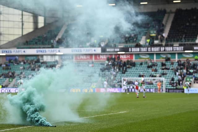 A green smoke bomb was thrown onto the Easter Road pitch during the 3-1 defeat by Rangers