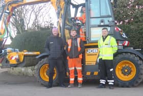 JCB Pothole Pro driver Stuart Dunlop (behind the wheel) is pictured with Mikey Hill, of Midlothian Council's roads service in the centre, along with David Stewart of the AA’s patrol team and Robin Bryant, far left, the joint MD of Scot JCB. Stuart, Mike and the roads team were about to tackle potholes just outside Carrington.