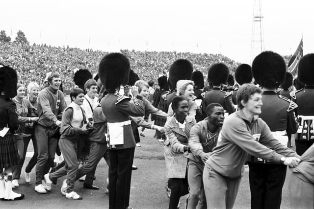 Competitors weaving a conga in and out of the pipers at the closing ceremony of the Commonwealth Games at Meadowbank Stadium, Edinburgh in July 1970.