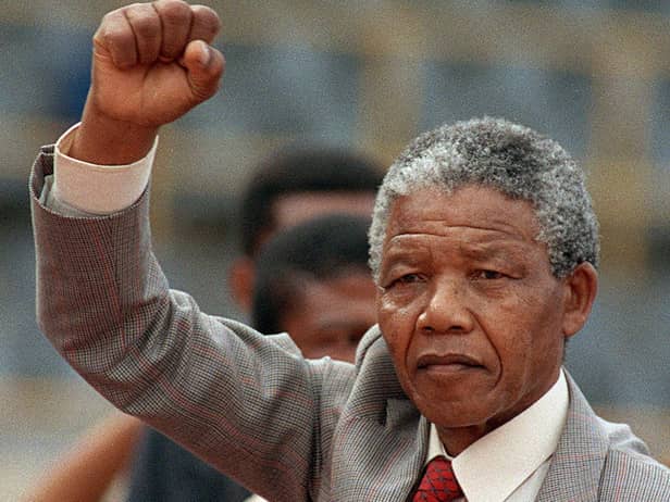 Nelson Mandela raises clenched fist at a rally following his release in 1990