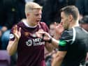 Hearts defender Alex Cochrane queries his red card against Celtic with referee Nick Walsh.