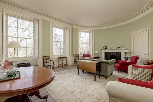 Drawing room with leafy views from all three windows, working shutters and a marble fireplace.