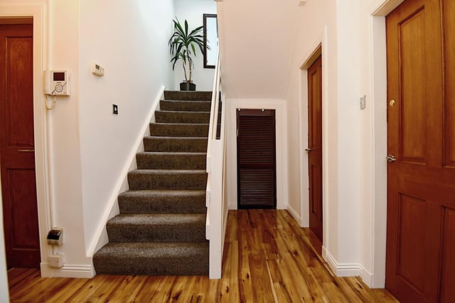 The ground floor hallway leads to four bedrooms, a sitting room, kitchen area, two bathrooms, and two sun lounges. Upstairs, there are two further bedrooms and a shower room.