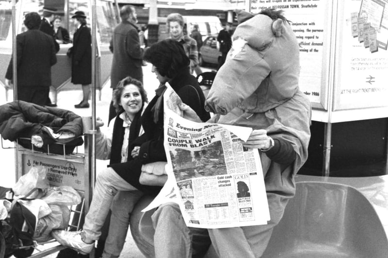 Hamish Taylor and Rob Roger dressed as a panto horse for Edinburgh Students Charities week fundraising in December 1986 - the horse reading the Evening News at Waverley station.