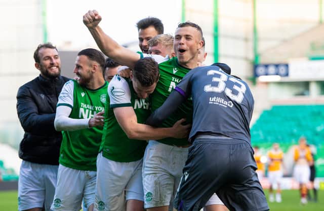 Jubilant Hibs team-mates mob Ryan Porteous after his winning penalty. Picture: SNS