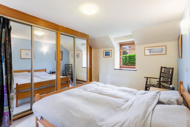 The principal bedroom benefits from a large built-in wardrobe with mirrored sliding doors.