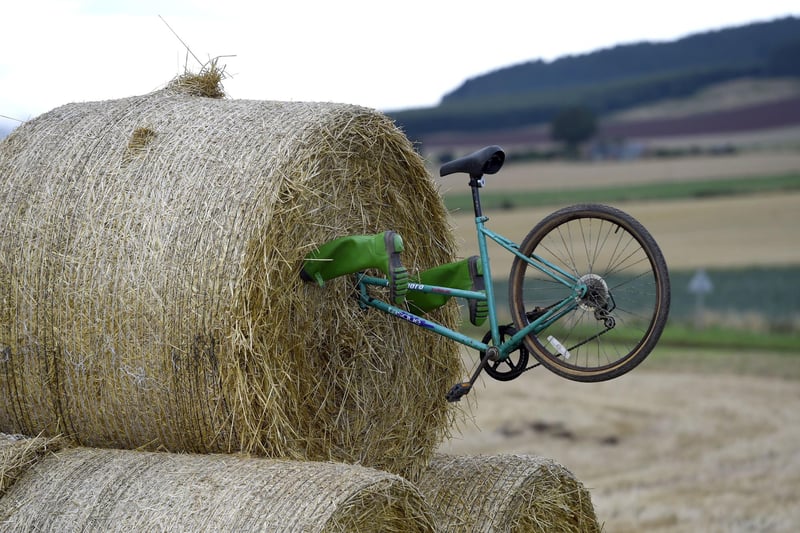 A bike and wellies sticking out of hay bales along the route of stage eight.