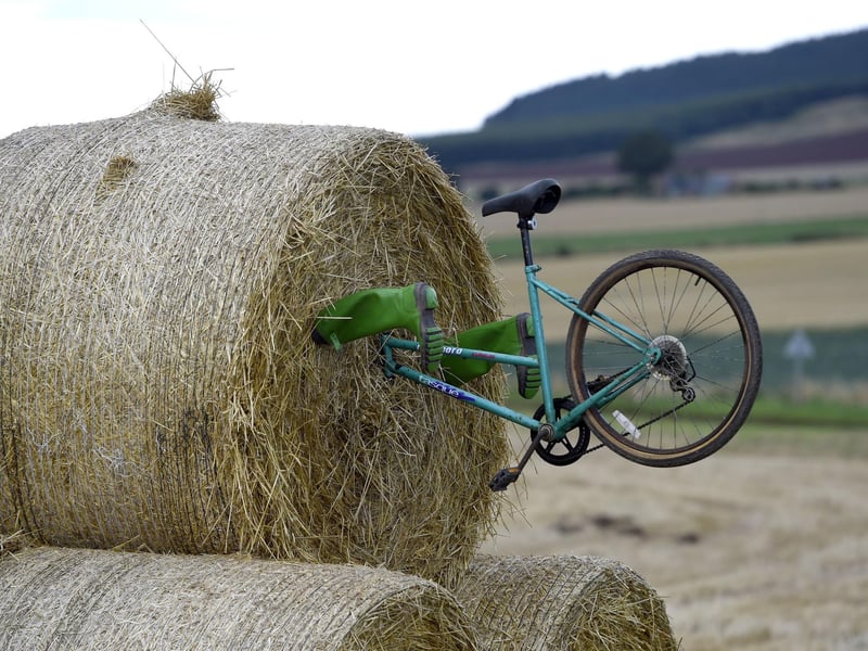 A bike and wellies sticking out of hay bales along the route of stage eight.