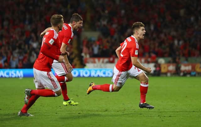 Ben Woodburn celebrates after scoring for Wales on his international debut. Picture: SNS