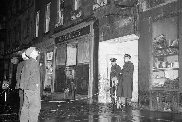 Two policemen are seen here guarding a Grassmarket tenement in November 1959. Residents had to be evacuated after a large crack appeared in the building.