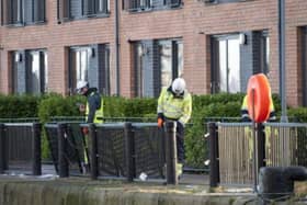 Wednesday 30th of December 2020: Workmen replace bollards and chains on the edge of the basin at Stevedore Place, in Leith Docks. Some residents have been upset at the replacement of the original bollards