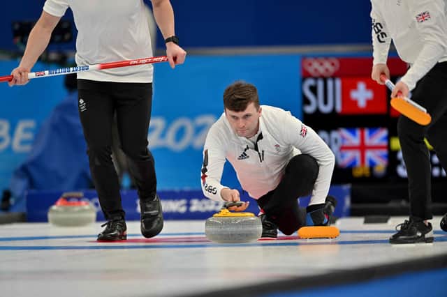 Great Britain's Bruce Mouat curls the stone during a tense round robin match against Switzerland