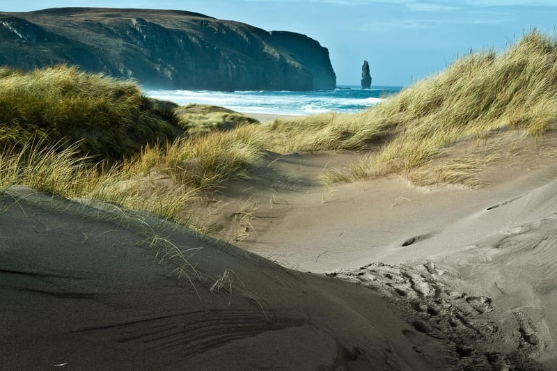 The wild and unspoiled Sandwood Bay has often been named the most beautiful beach in Britain. Located in Kinlochbervie in the north west coast of Scotland, it is backed by huge sand dunes and a freshwater loch. It has received on average 6,600 searches a month
