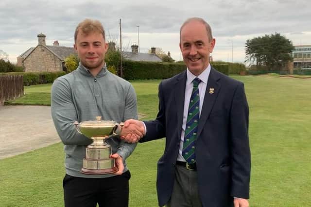 Matty Wilson receives the Craigmillar Park Open trophy from club captain Craig Murison. Picture: Craigmillar Park Golf Club