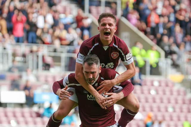 Cameron Devlin celebrates Hearts' first goal with Michael Smith.