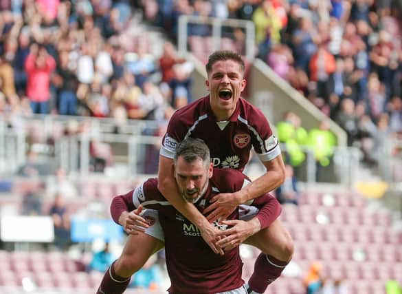 Cameron Devlin celebrates Hearts' first goal with Michael Smith.