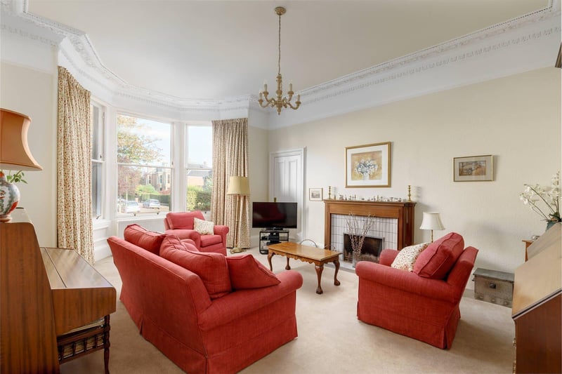 The spacious bay windowed living room overlooking the front garden with open fireplace and plenty of space.