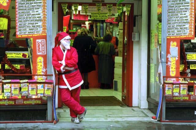 A member of staff at Richer Sounds music equipment shop, dressed as Santa Claus to welcome the Chrisrtmas shoppers in December 1992.