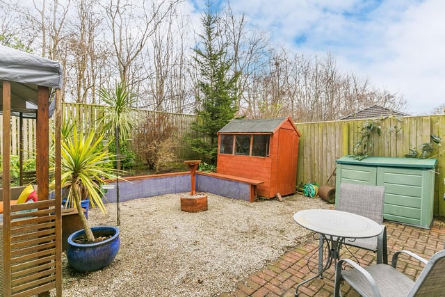 The well presented garden area comes with plenty of space and this shed.