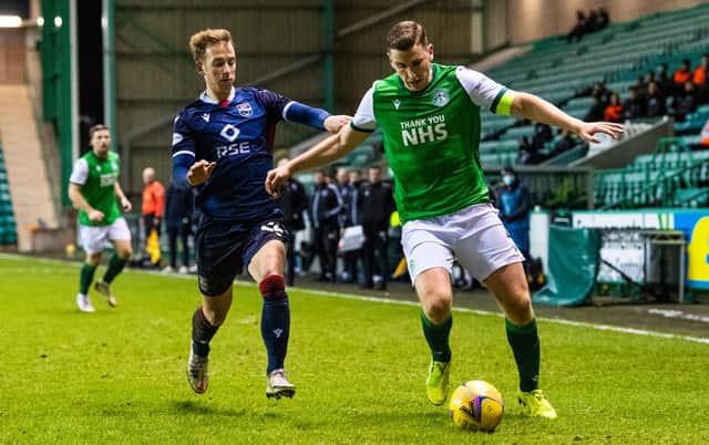 Paul Hanlon of Hibs holds off Ross County's Harry Paton during the last encounter between the two teams