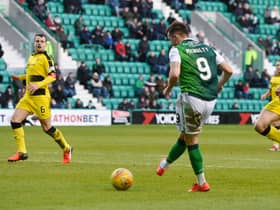 Marc McNulty scores for Hibs against Raith in the lat competitive meeting between the two sides as Iain Davidson, right, looks on