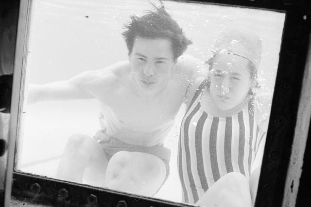 Bathers John Charity and Susan Kelman look through the observation window at Portobello Outdoor Swimming Pool in 1964.
